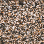 Beach stones surface. Sea pebble texture. Marine mineral beauty harmony.