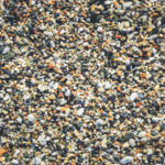 Sea pebble texture. Beach stones surface. Marine mineral beauty harmony.