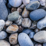 Marine mineral beauty harmony. Sea pebble cobblestones texture. Beach stones surface.