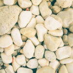 Beach stones surface. Marine mineral beauty harmony. White sea pebble cobblestones texture.