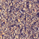 Lot of small stones on the beach with little pebbles texture. Nautical marine background.