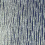 Sawn lot of cross dashes blue granite wall texture. Granite surface background.