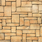 Masonry stone cladding wall texture. Geometric shapes surface background.