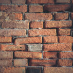 Weathered red bricks wall texture. Building stone surface background.