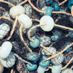Mixed up fishnet with rope and lot of buoys texture, Nautical marina background.