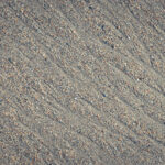 Wet sand water stock texture. Summer beach background.