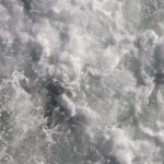 Sea wave foam texture. White marine aqua motion surface background. Outdoor water froth swirls backdrop.