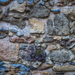 Stones wall texture. Rocky cliff stones surface background.