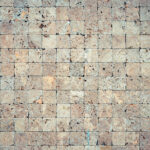 Square stones surface background. Travertine masonry tiles cladding wall texture.